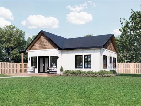 Image of a two-bedroom, custom accessory dwelling unit with white, vinyl siding, a black roof, and double glass patio doors located in the backyard of an Atlanta home. 