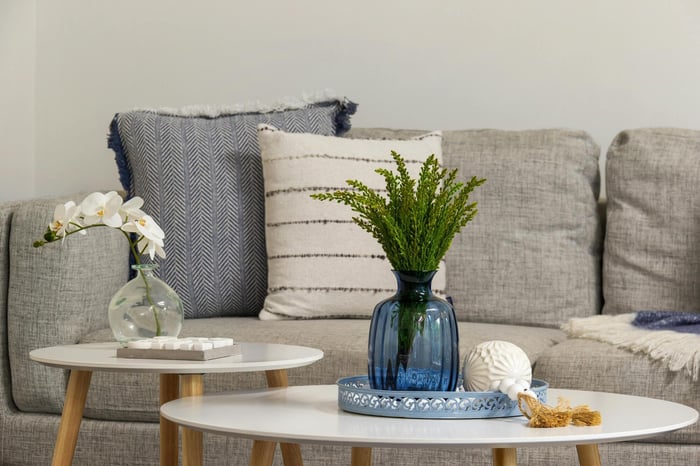 Modern living area with white tables and green plant decor in a Smart Spaces ADUs custom home in Georgia - stock