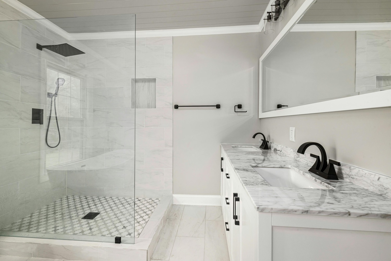 Marble countertop and black fixtures in modern bath remodel by SmartSpaces ADUs in Brookhaven, GA Marble countertop and black fixtures in modern bath remodel by SmartSpaces ADUs in Brookhaven, GA