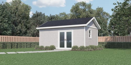 Image of a Prefabricated accessory dwelling unit in the backyard of an Atlanta, GA, home with a dark grey roof, light grey vinyl siding, and double glass front entry doors.